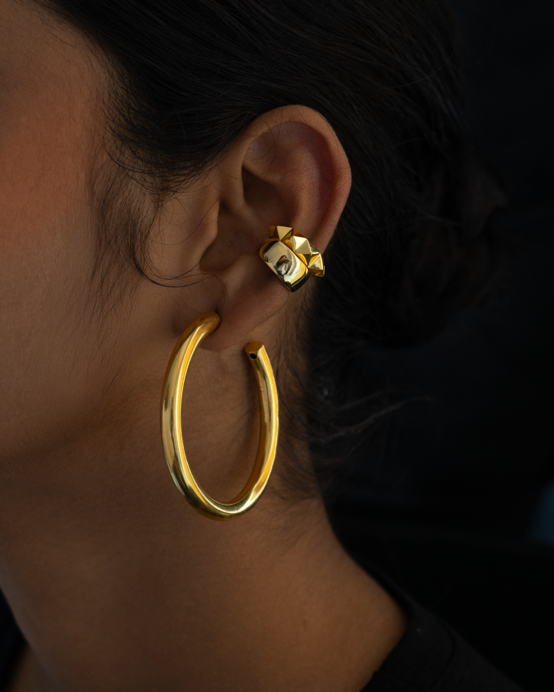 Unique hoop earring combo with earcuffs for a balanced sophisticated look.